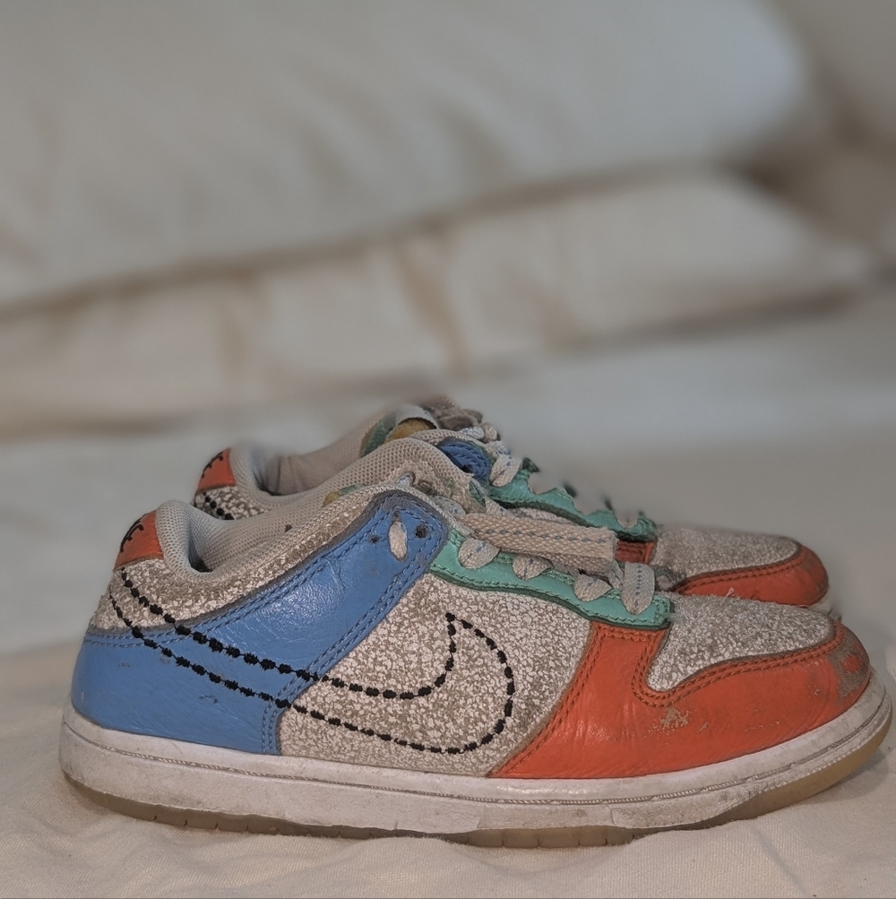 Nike Dunk Low "Nike 101" sneakers featuring a multicolor design with cracked lea